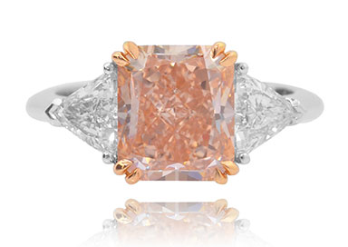 A 4.82 carat LEIBISH Fancy Orangy Pink and trilliant collection color 3 stone diamond ring
